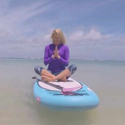 Lady doing yoga on a paddle board